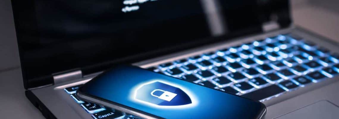 featured image article +11 Quick Tips to Be Safe Online" showing laptop and a smartphone on top with a cyber lock symbol on the screen