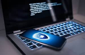 featured image article +11 Quick Tips to Be Safe Online" showing laptop and a smartphone on top with a cyber lock symbol on the screen