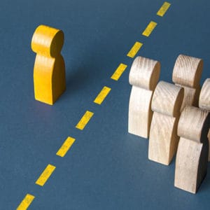 Featured image for solutions for the article "Breaking down Communication Barriers" showing communication a person and a group of people are separated by a yellow line