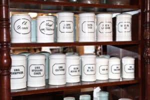 Old white glass medicine containers on the shelf