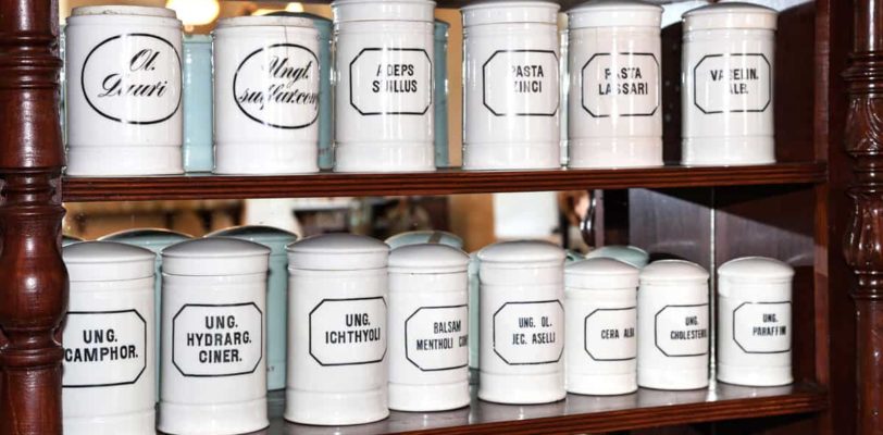 Old white glass medicine containers on the shelf