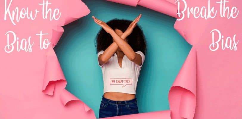 Featured image for article "Know the Bias to Break the Bias" for the International Women's Day 2022 with the motto #BreakTheBias, showing a woman breaking through a pink paper background with her arms in an X pose
