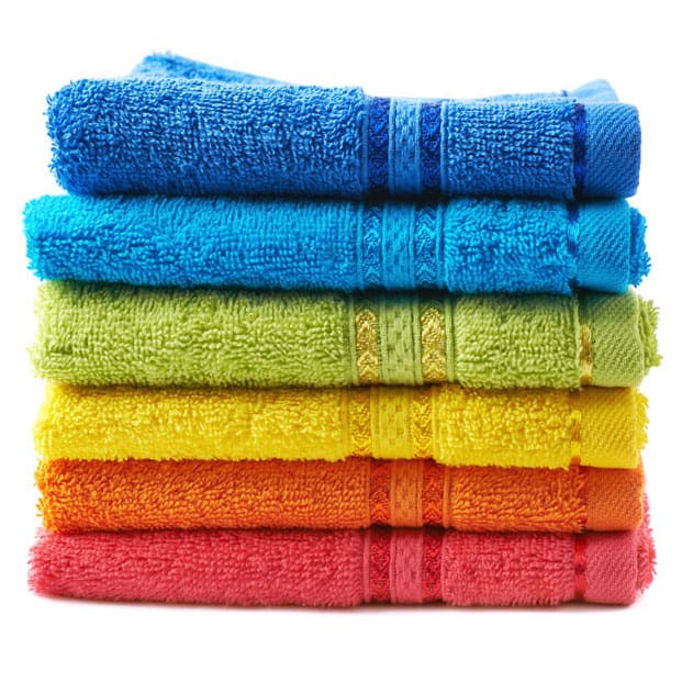 Pile of rainbow colored towels isolated