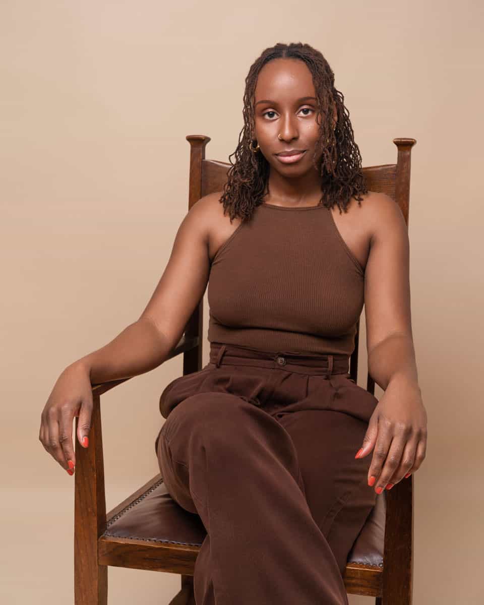 Role Model Ire Aderinokun sitting on a chair