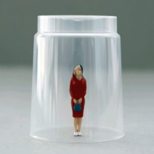 Visual for article "Stuck between Glass Ceiling and Glass Cliff -Basics- Part 1"; woman stuck under a glass