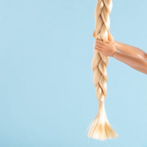 featured image of article "The Rise of the Rapunzulas" about emowering women and helping others climb the ladder. blue background. blond hair and hands climing up