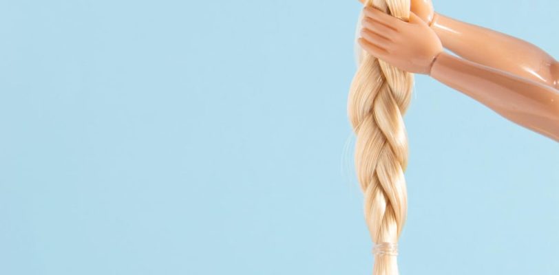 featured image of article "The Rise of the Rapunzulas" about emowering women and helping others climb the ladder. blue background. blond hair and hands climing up